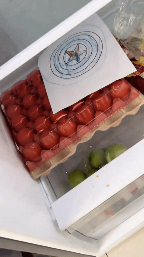 kid's drawing on top of egg tray inside the fridge