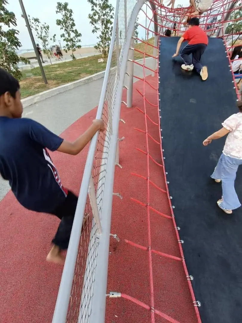 kids playing at the damaged playgroud at the newly opened park, Phase 1 of Taman Gurney Bay