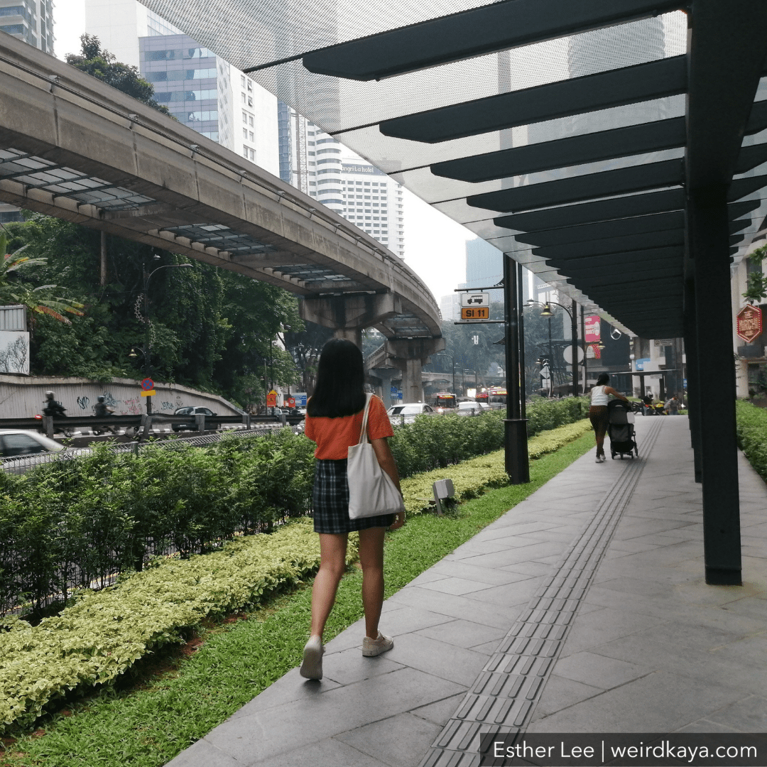 Young M'sian woman walking in KL city