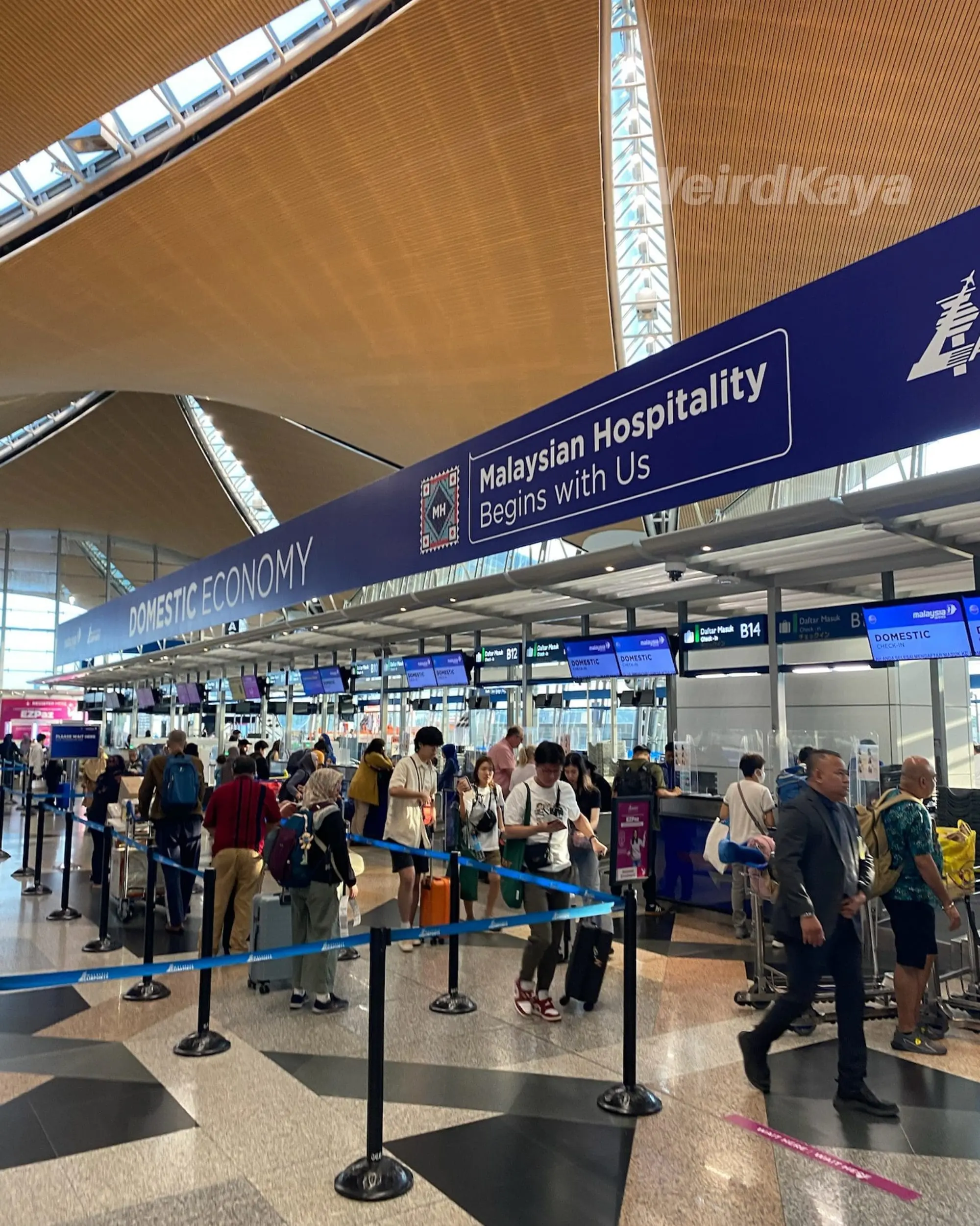 KLIA airport lobby departures luggage check in counter and queue