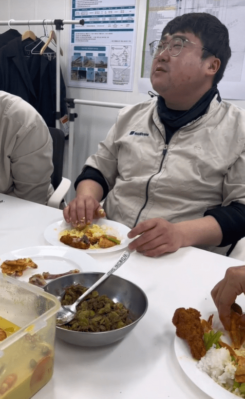 Korean man eating with his hands