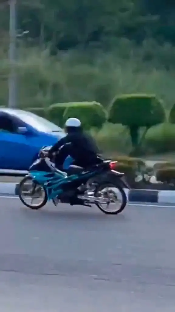 M'sian Uncle Dressed In Sarong Waves Wooden Stick At Mat Rempits On 1st Day Of Raya