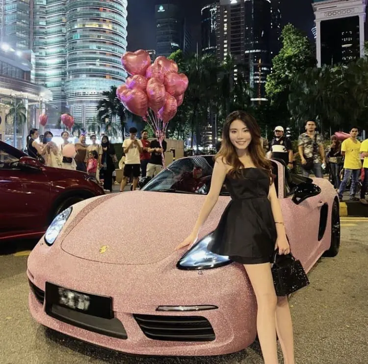 Jun Jun posing with her Porsche
