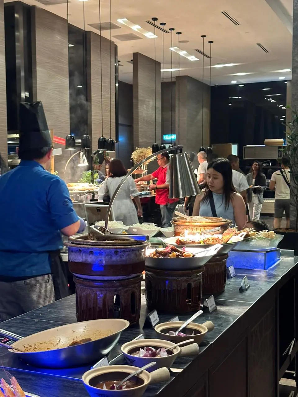 People taking their food at a buffet 