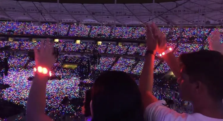 Fans cheering and clapping at Coldplay concert