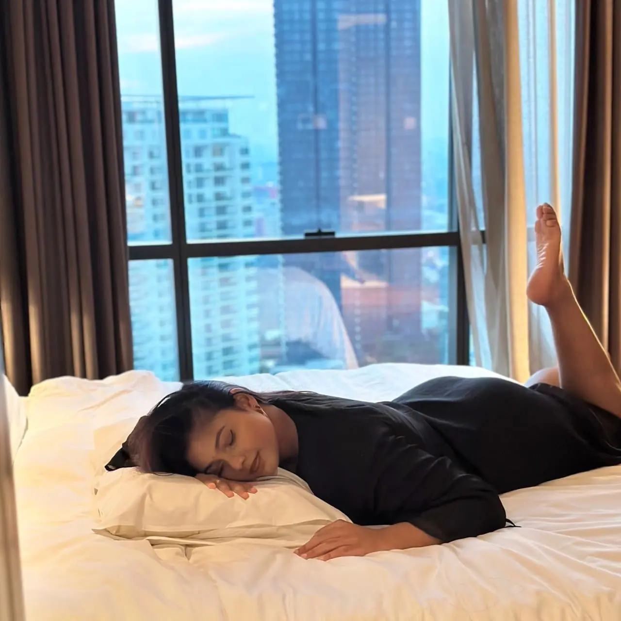 Msian woman sleeping on a bed