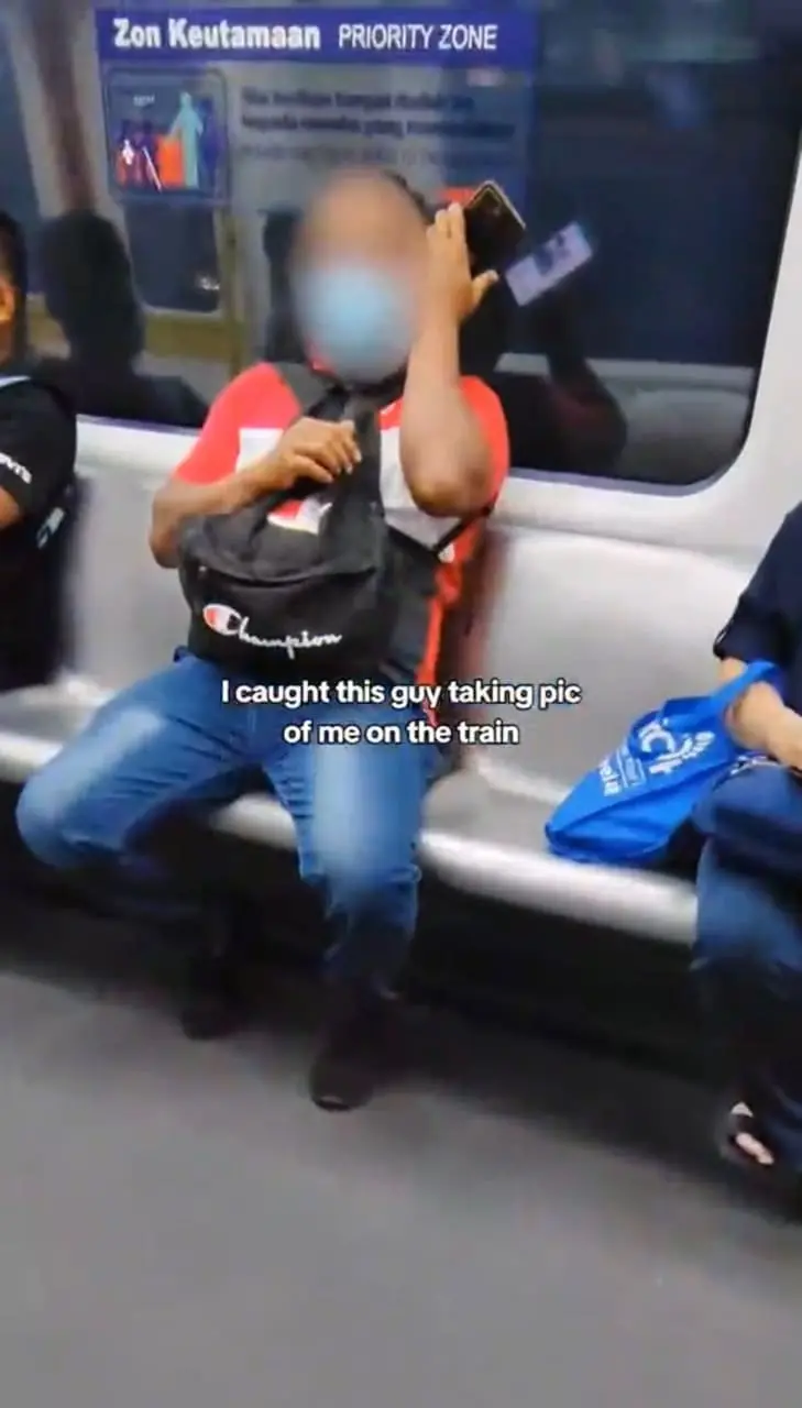 Man secretly taking picture of a girl in the LRT