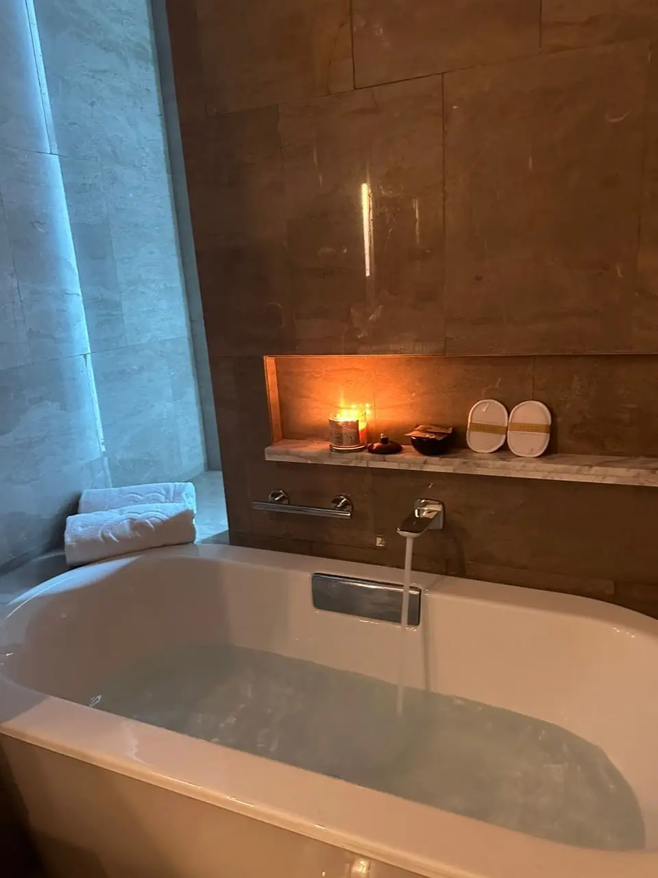 Bathtub in Sofitel Kuala Lumpur with free towels and candles