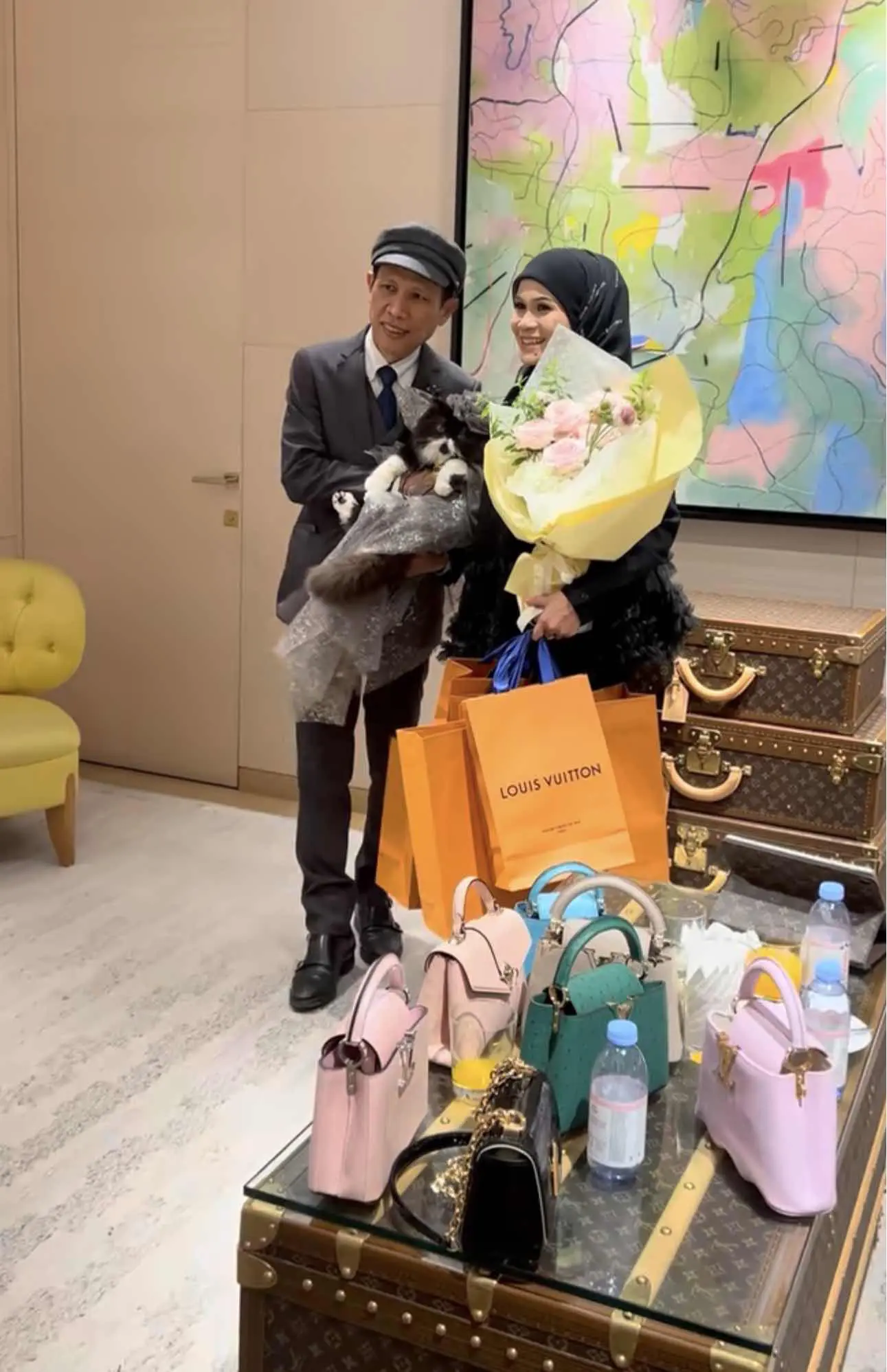 cat's family taking pictures with the gifts and a bouquet