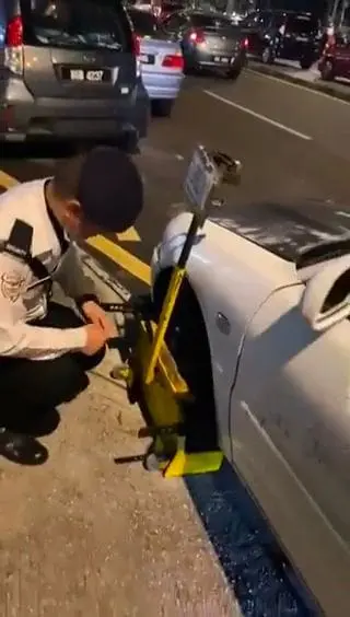 M'sian Driver's Illegally Parked Car Receives Fine, Wheel Clamp and Vandalization - Has 12 Unpaid Traffic Offenses Too