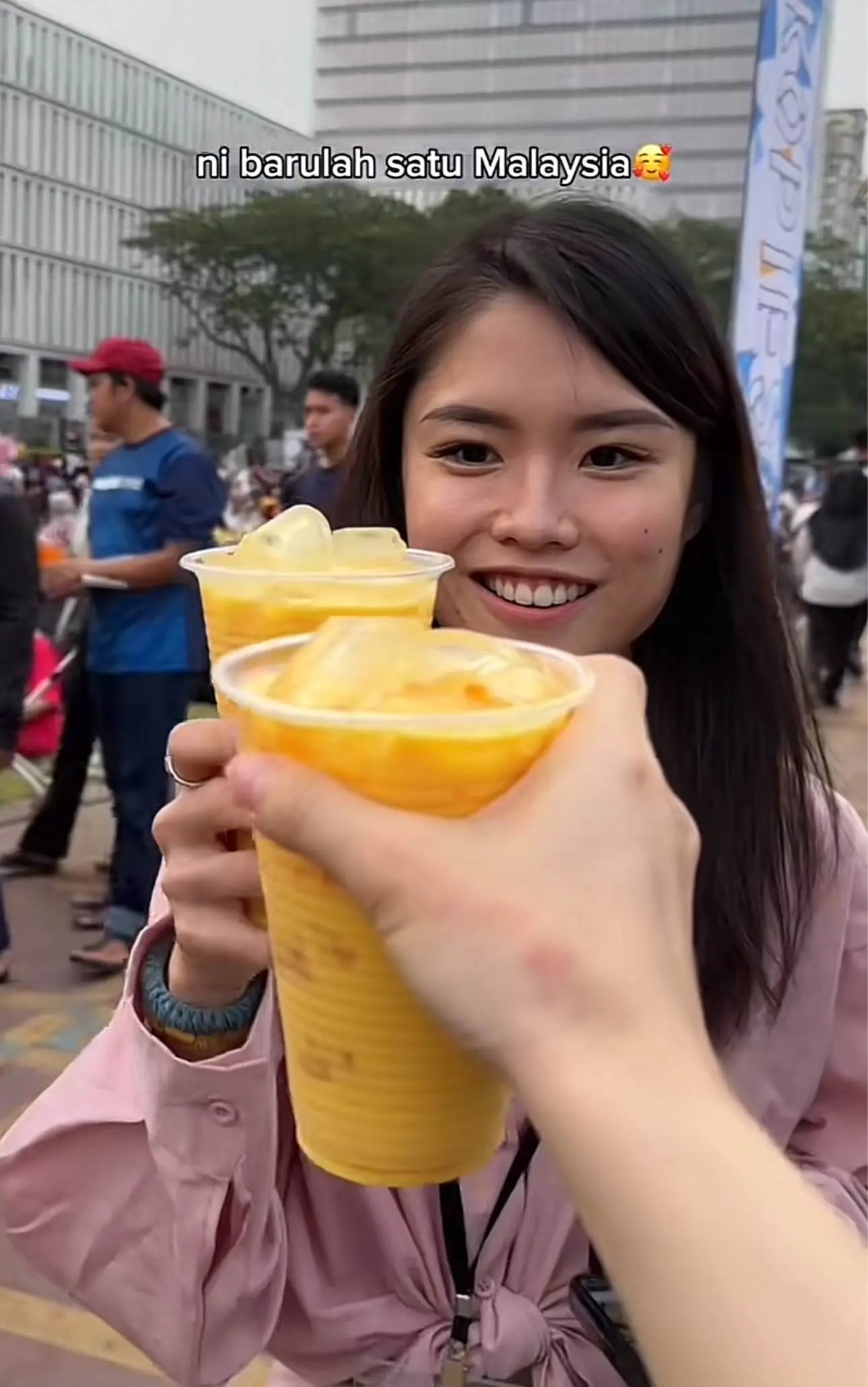 Two chinese woman cheers drinks at Putrajaya Square