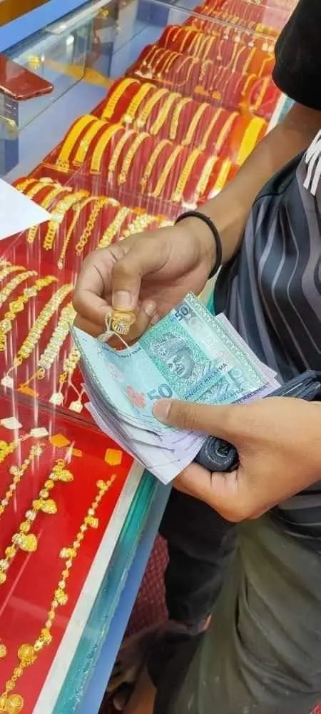 Teen showing the gold he bought with his money