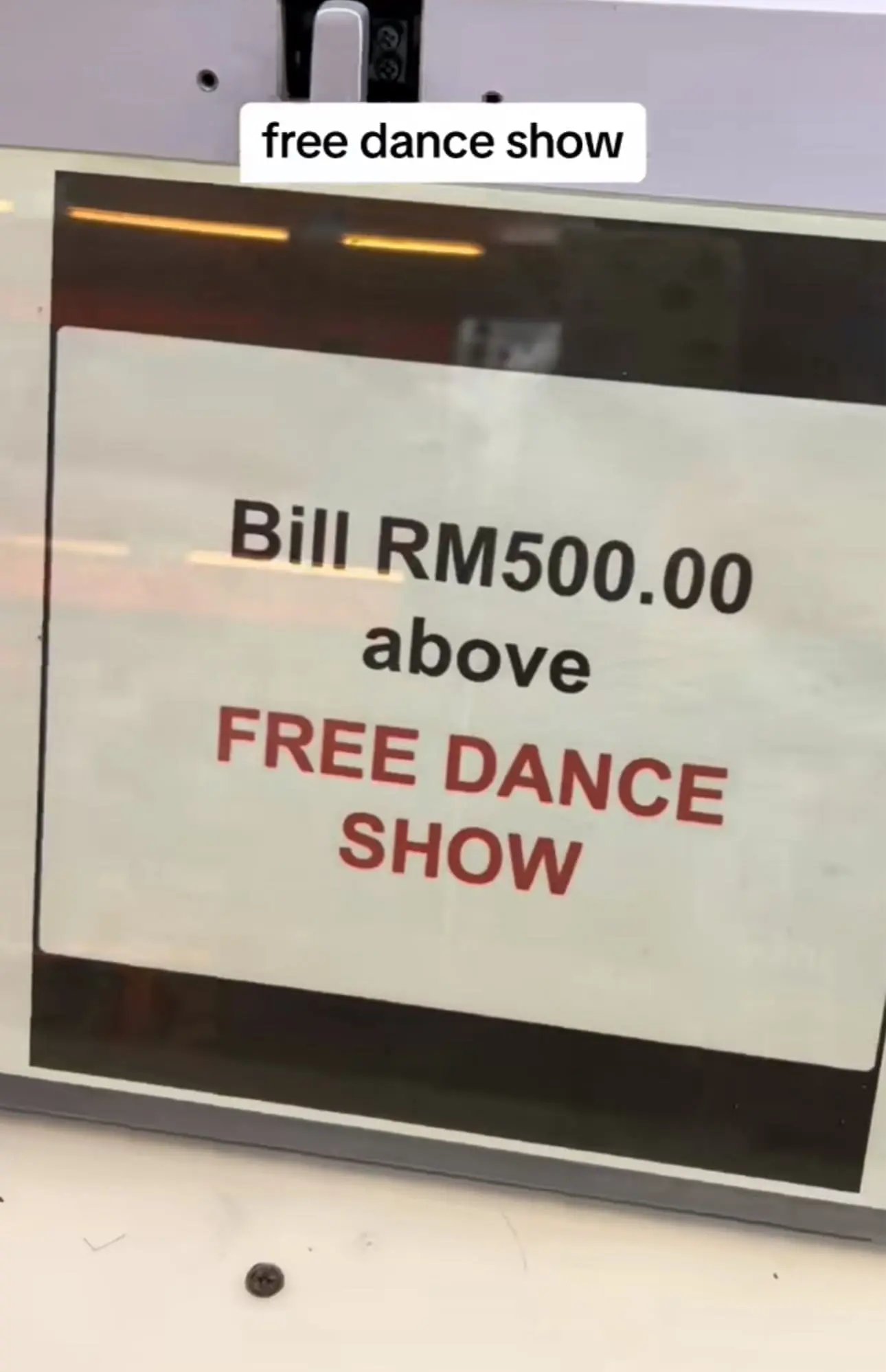 Display showing free dance show available after purchasing RM500 or more
