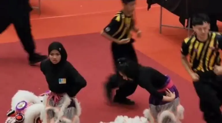 Malay girl and Chinese partner at the end of performance