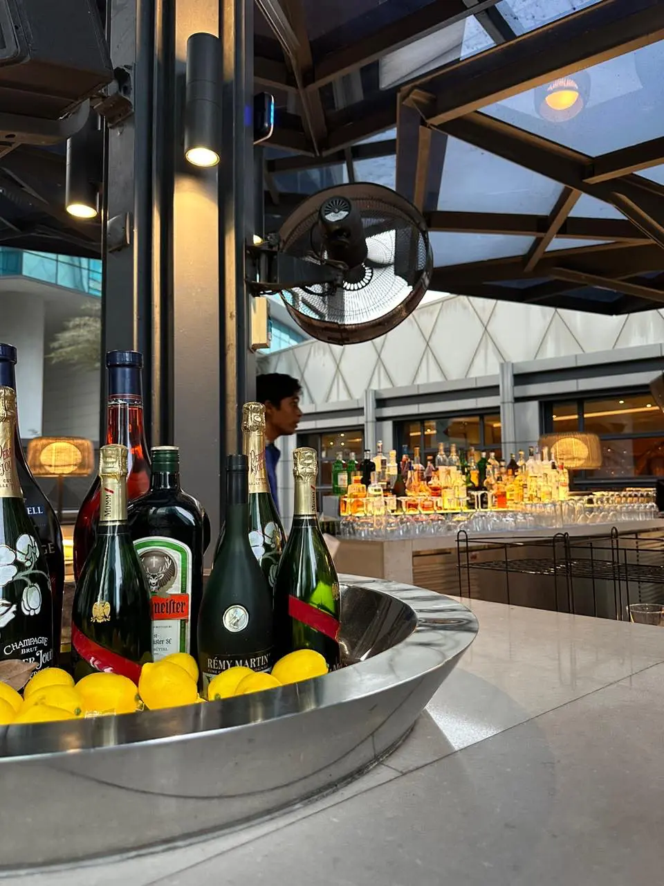 Pool bar with different types of alcohol arranged on the pool bar table