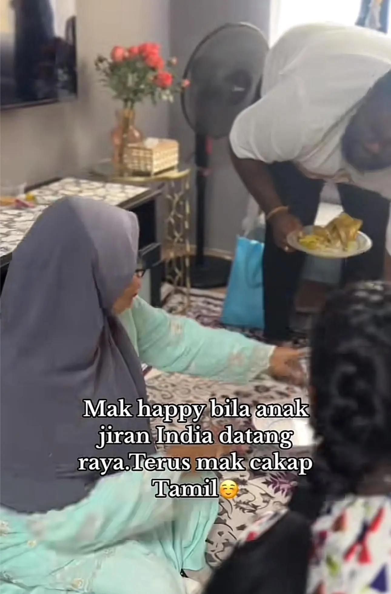 Hasimah Saman was seen warmly coaxing her neighbors to eat