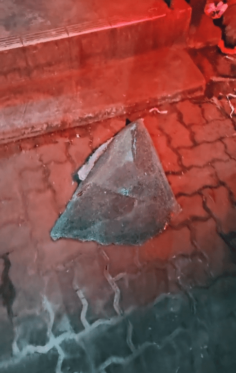 Large piece of glass window on the ground