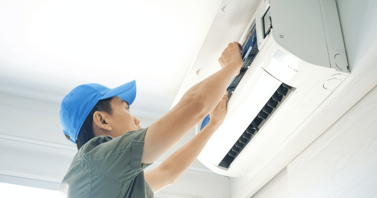 man fixing aircond