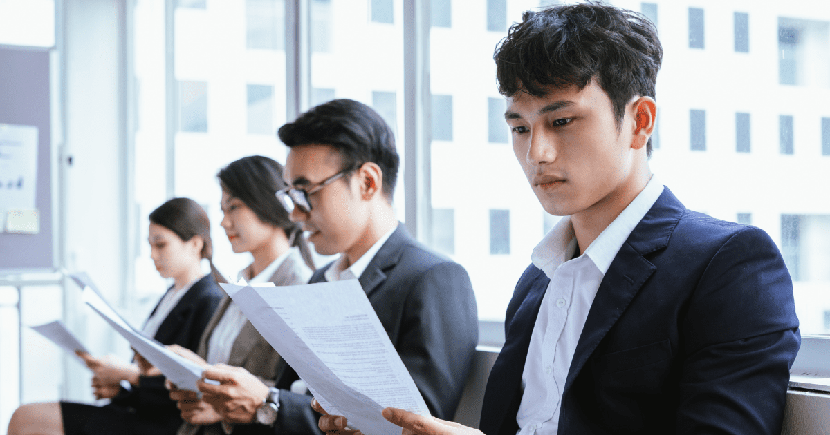 Asian people holding documents