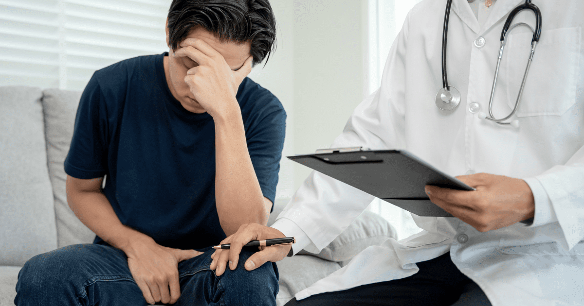 man looks stressed with doctor consoling him