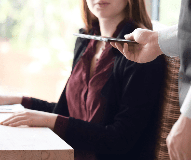 bill tab handed to woman