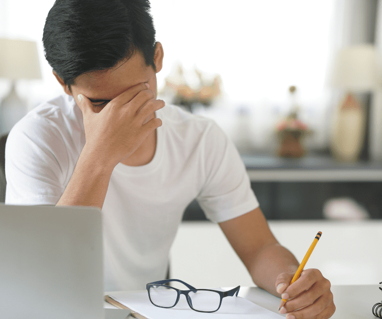 male student stressed over workload