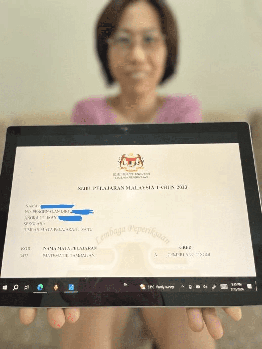 Liu Xiulian showing her SPM results