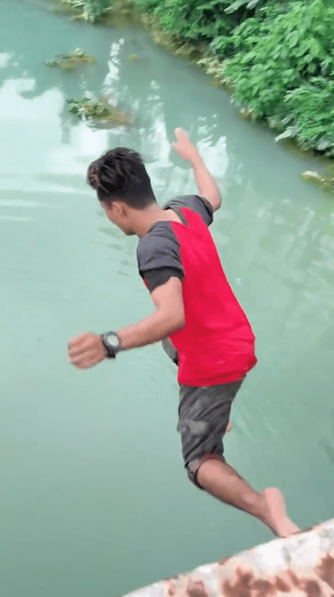 Msian jumping off a bridge into the jade green river at Machang, Kelantan