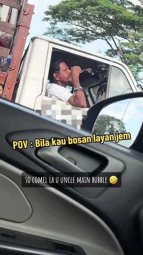 lorry driver playng bubble toy in traffic jam