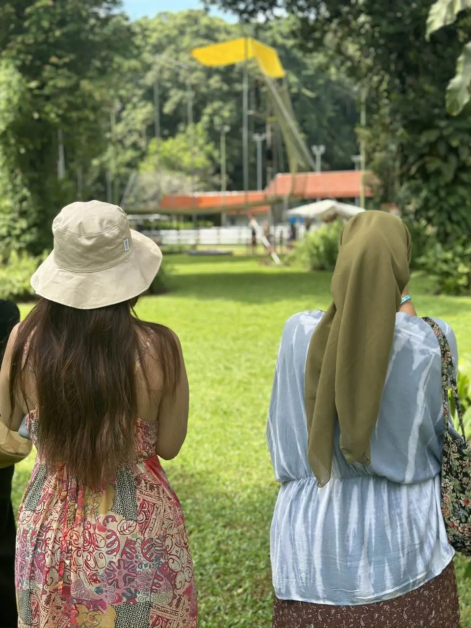 Two girls taking picture of the trapeze