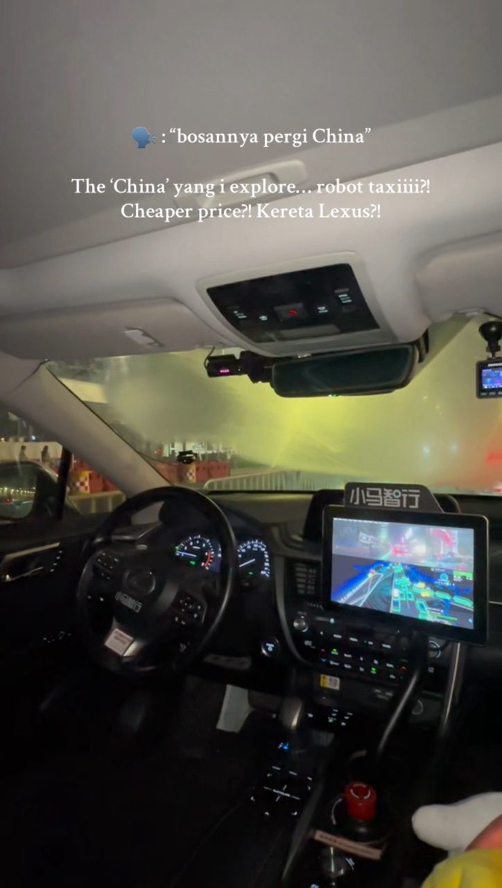 msian rides self-driving taxi in China screen