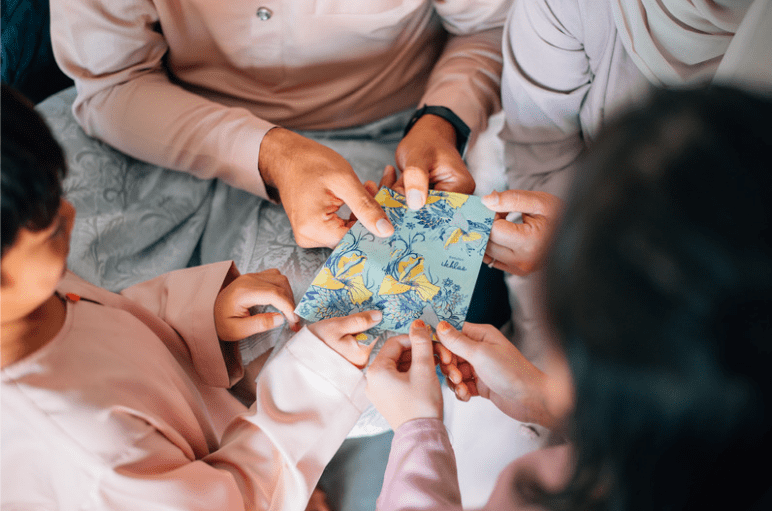 Malay family giving out duit Raya