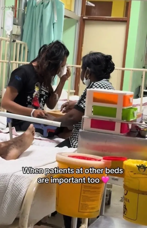 malay man crying while auty feeds him