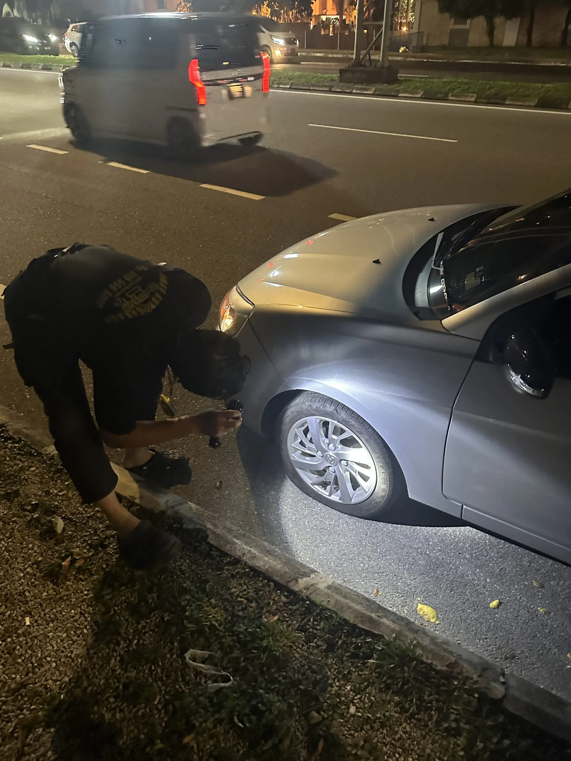 Malay uncle checking the tyre