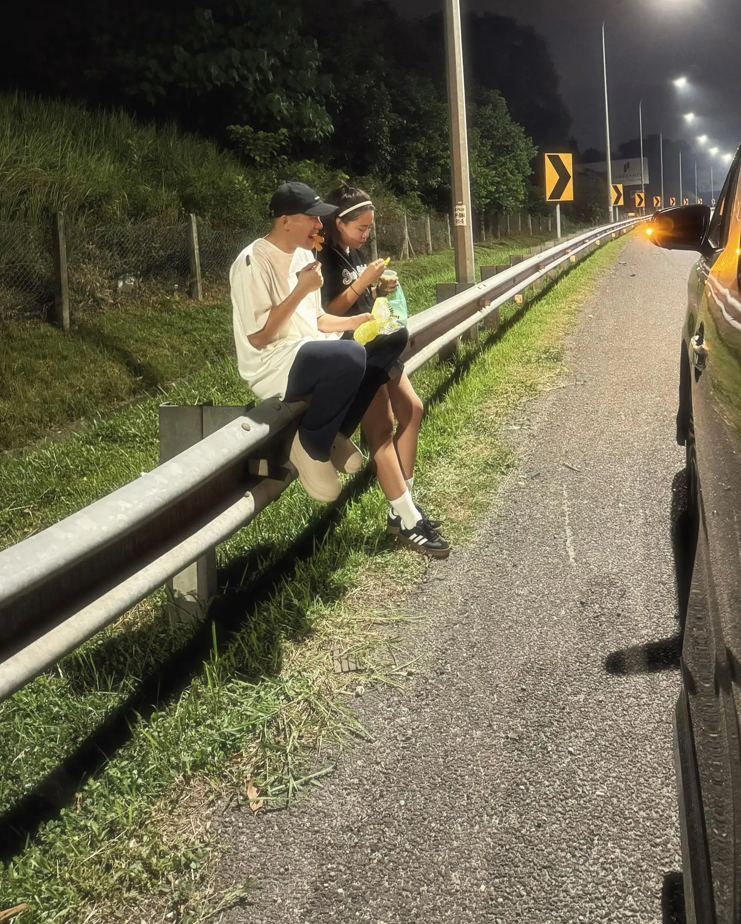 Malaysian content creator Phei Yong eating at the side of road on a highway