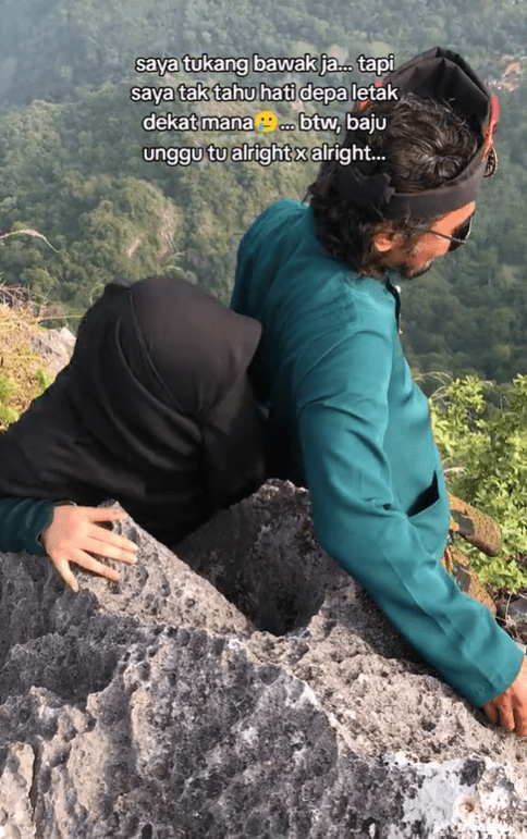 M'sian man and woman hiking Gunung Pulai in malay clothing