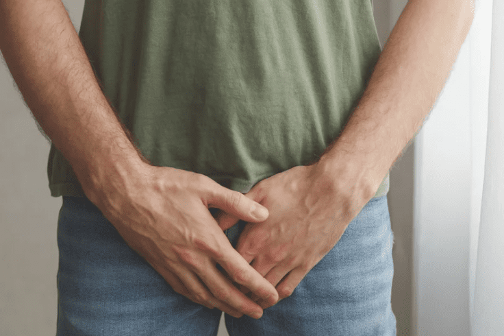 Man covering his crotch