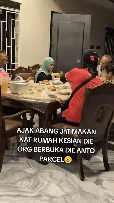man is eating with a msian family for iftar