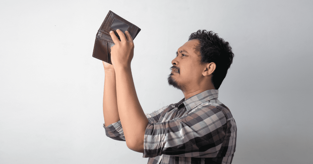 man looking at his wallet