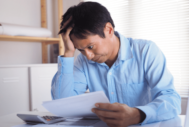 man looking stressed reading the document