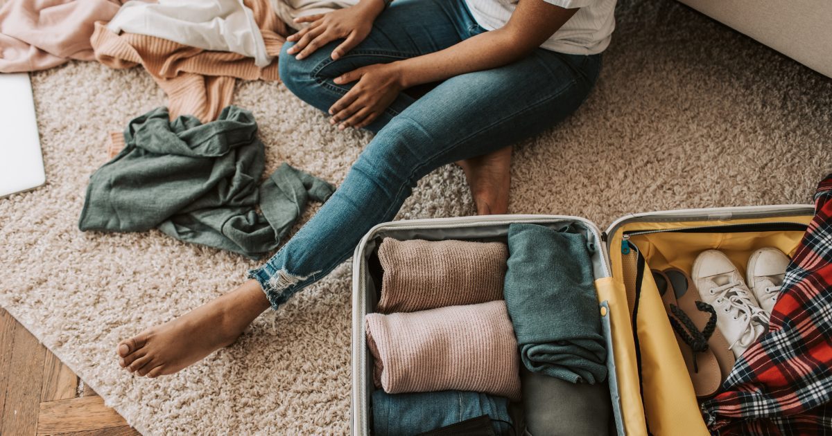 man packing his items inside luggae