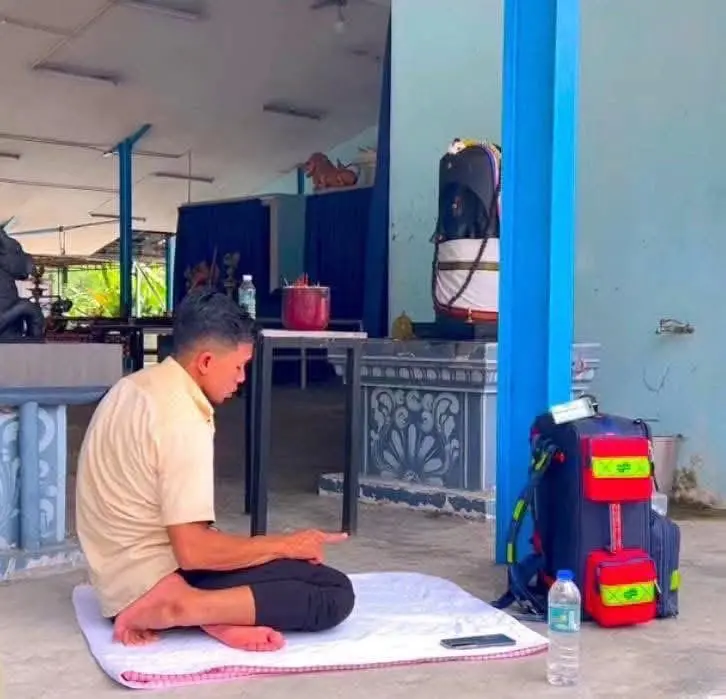 Man performs prayers at the temple
