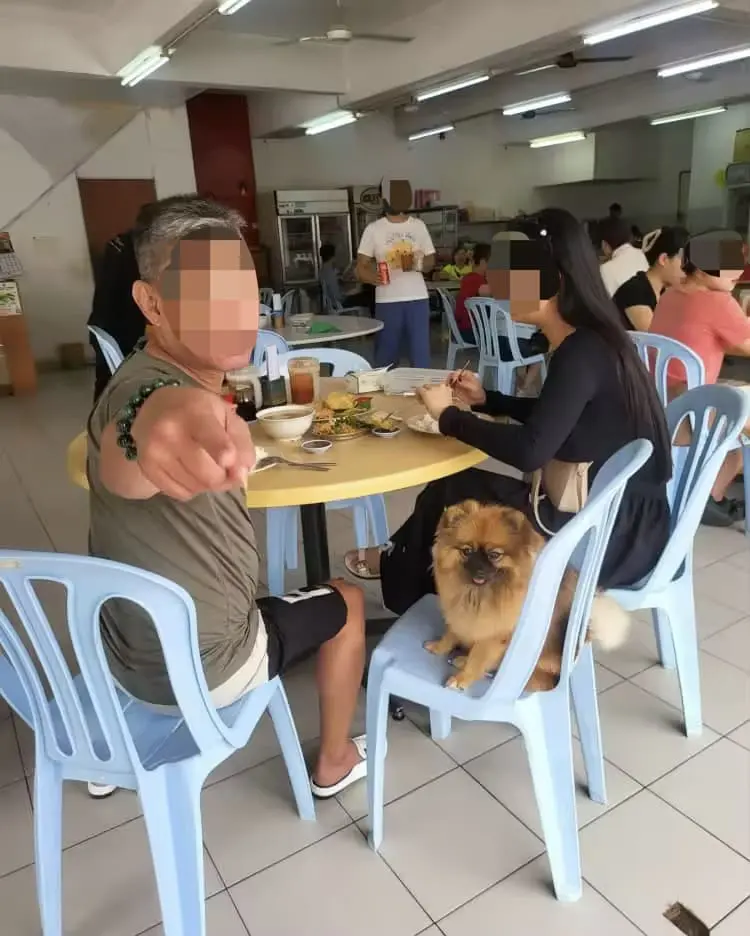 Man points angrily at woman who confronted him over pet dog