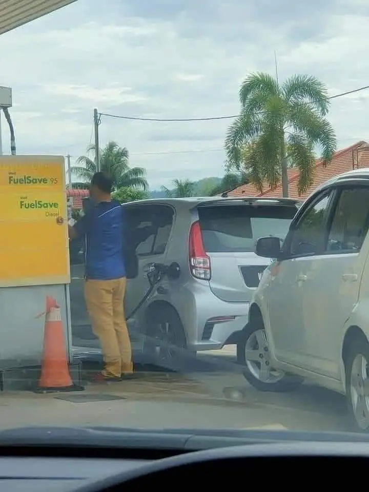 Man pumps Myvi with diesel