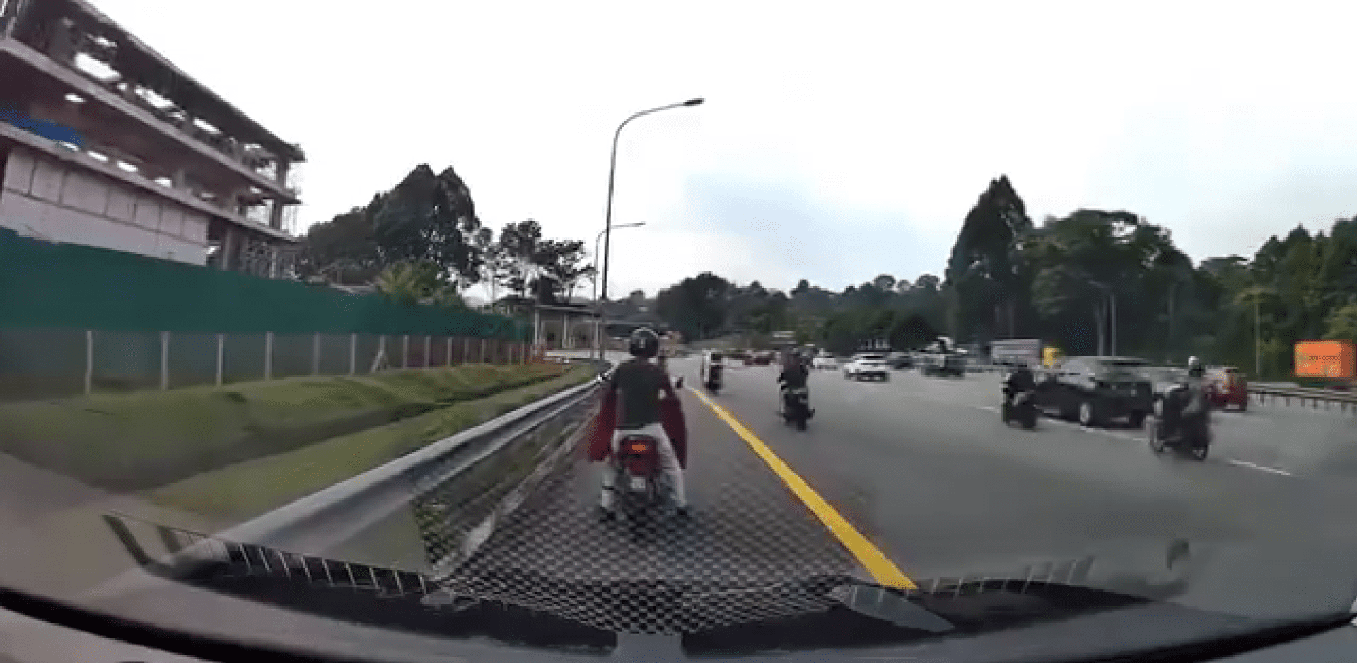 man pushing his motorbike on road