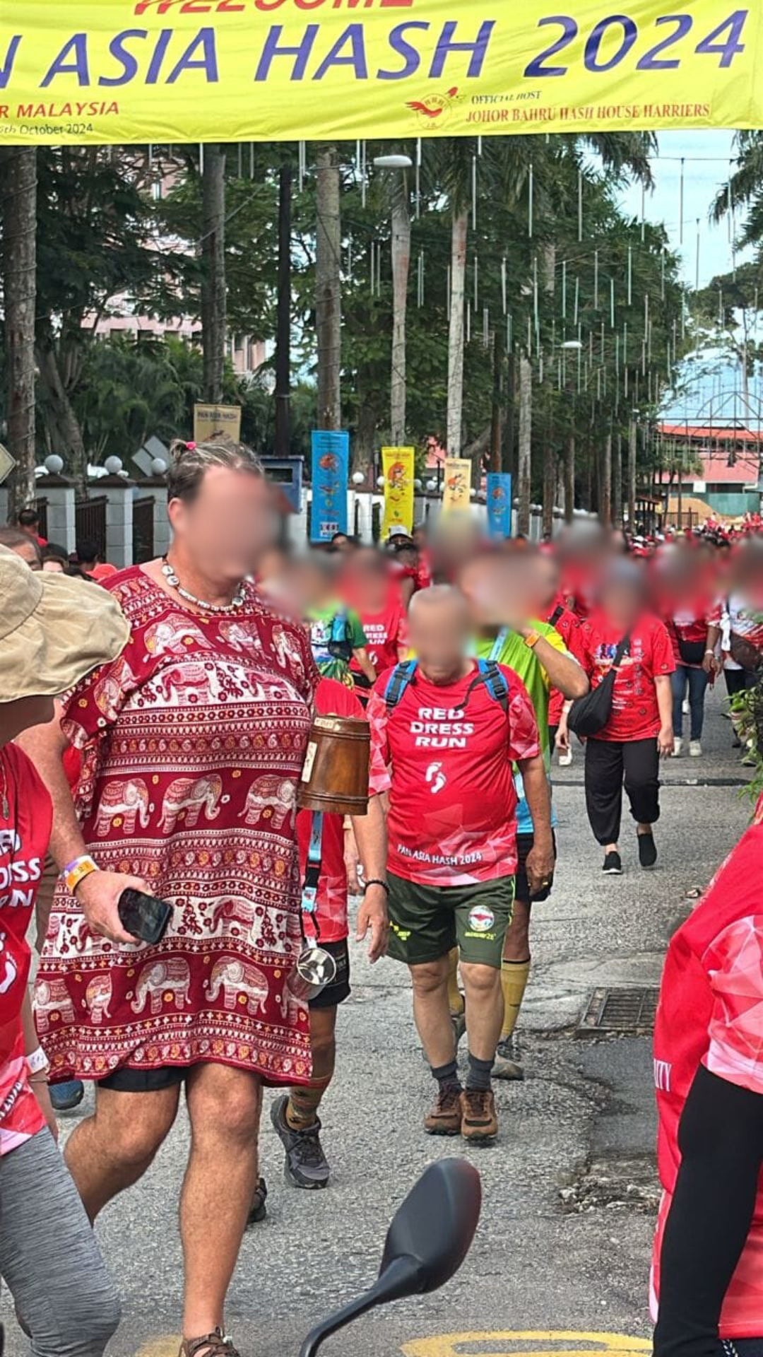 man running in red dress at  Pan Asia International Run