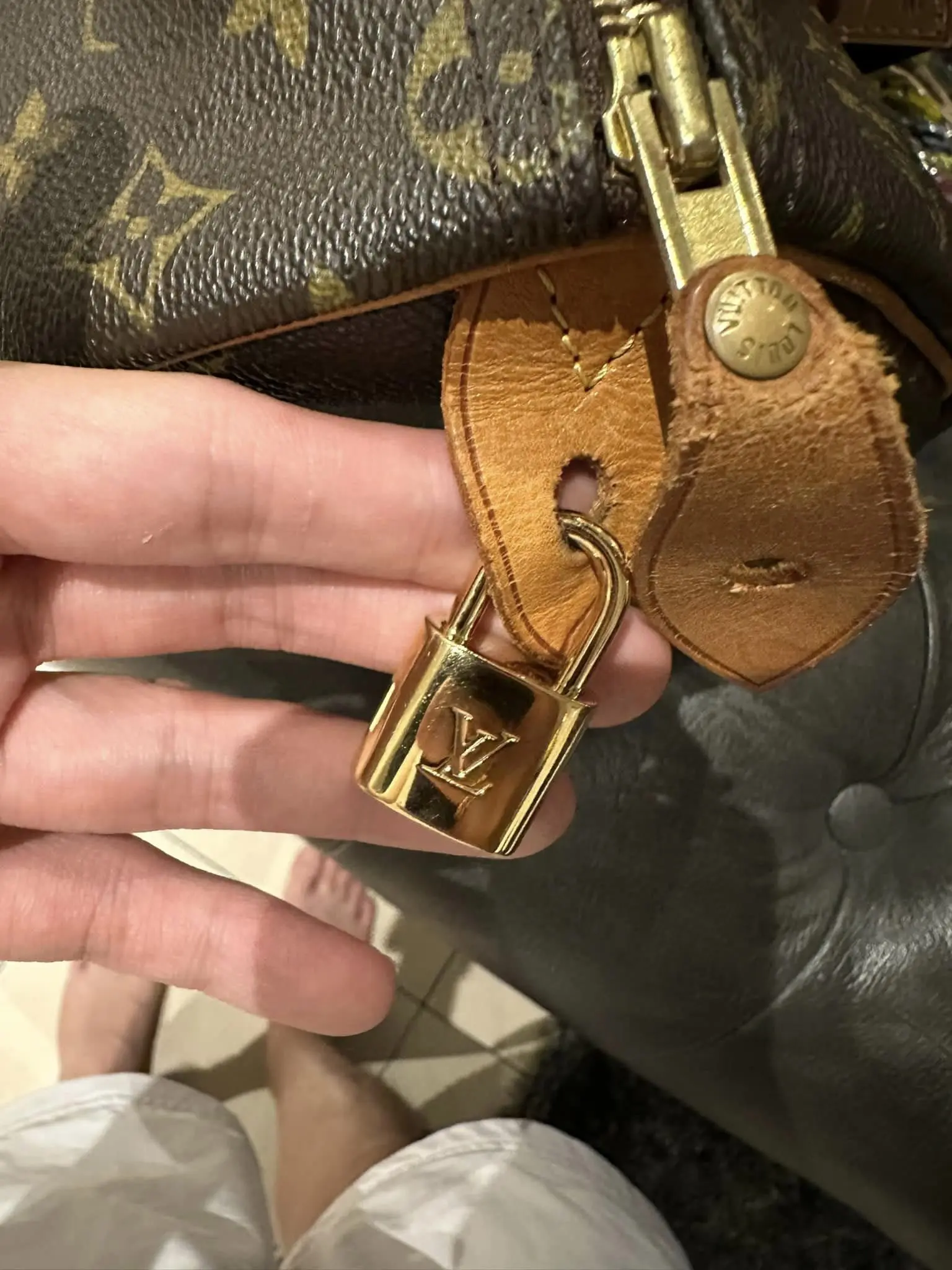 man showing a mini padlock in his bag