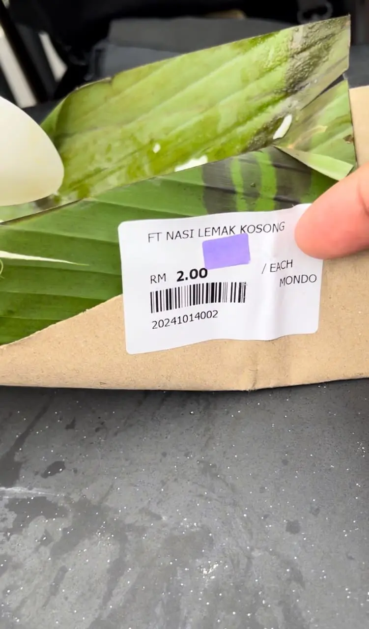 man showing the price of nasi lemak 