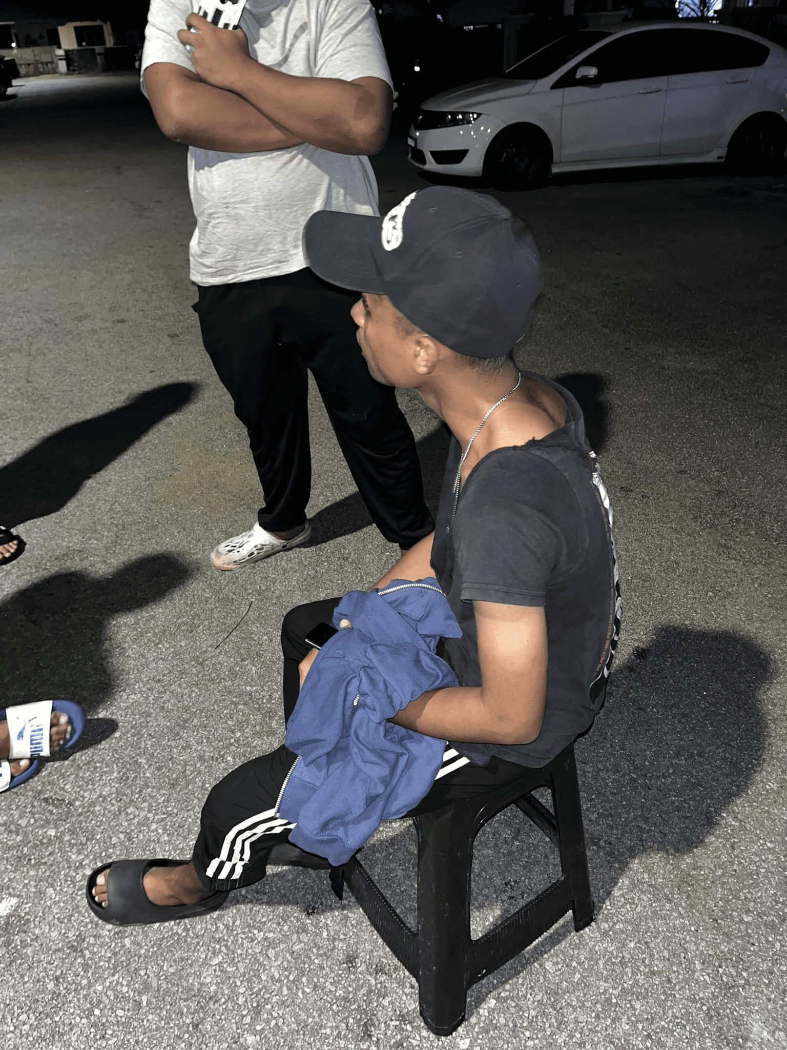 M'sian man sits on a chair after he was assaulted over RM9 burger order