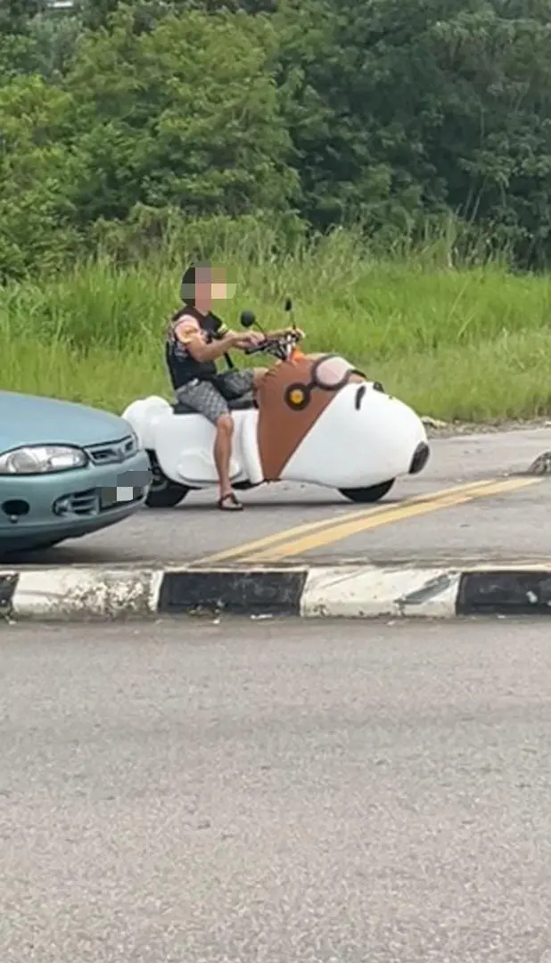 man sitting on the snoopy bike